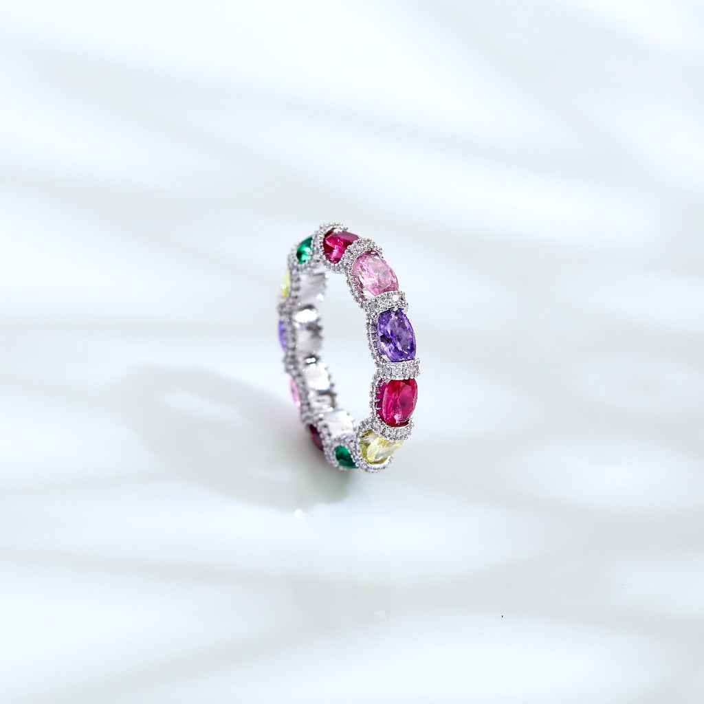 Ring with multicolored gemstones on a white background