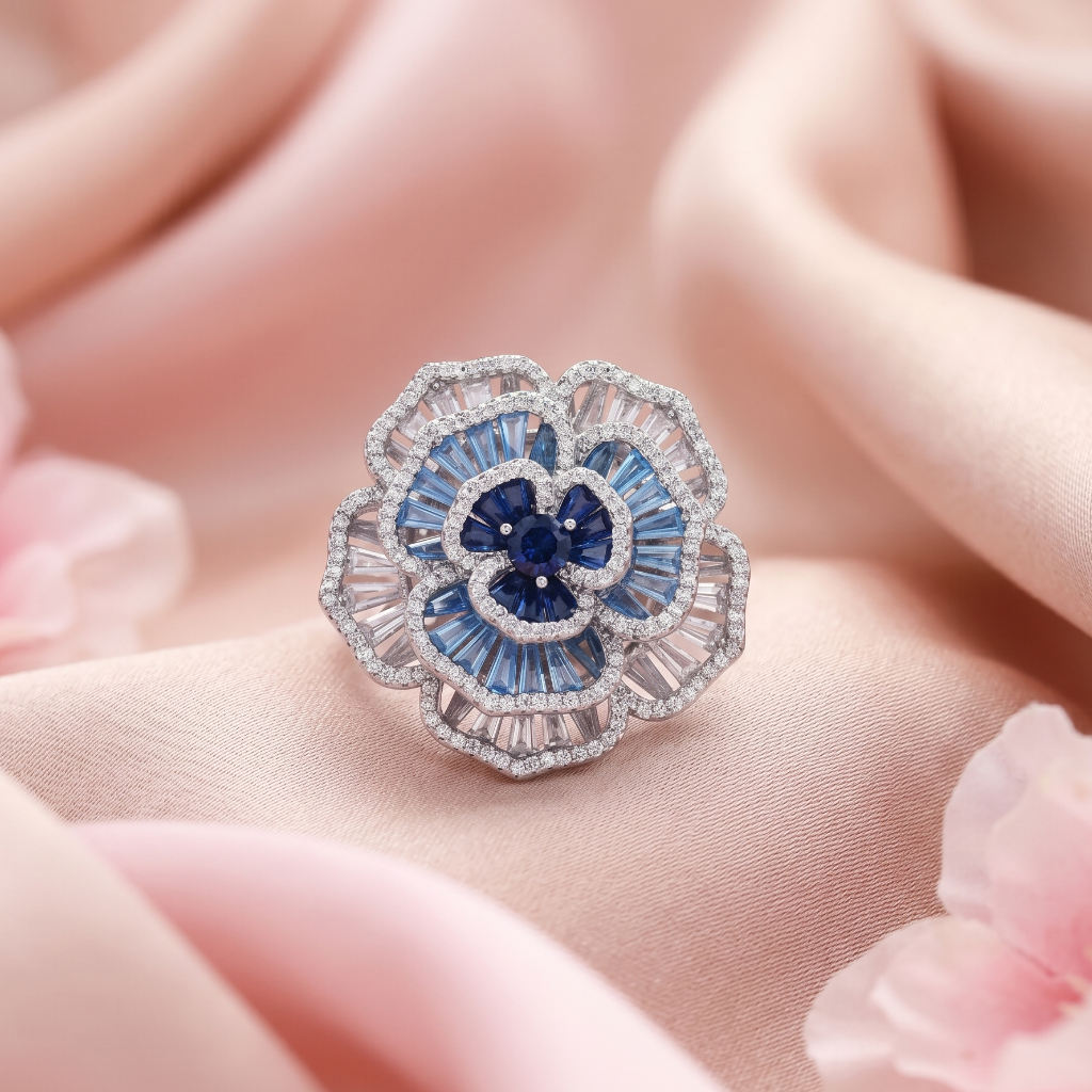 Elegant ring with blue gemstones and diamonds on a soft pink fabric background