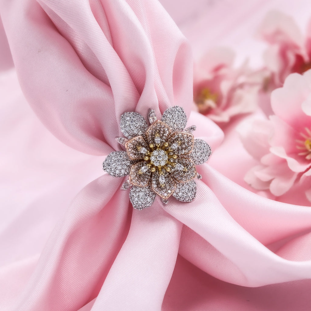 Decorative brooch on pink fabric with a blurred floral background