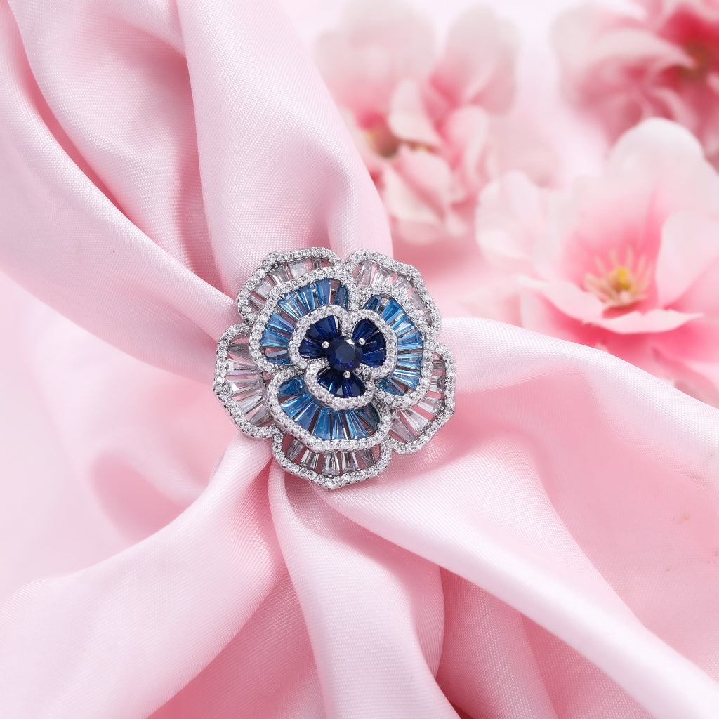 The Bloom That Remembered The Sky floral statement ring featuring sapphire blue crystals, pastel crystal petals, and brilliant zircon detailing by Kohizen