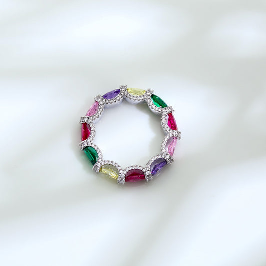 Multicolored gemstone ring with silver band on a white background